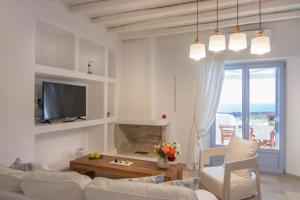 a white living room with a couch and a table at Passos Villas in Parasporos