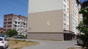 ゼレノグラーツクにあるАпартаменты Зеленоградскの駐車場車の入った建物