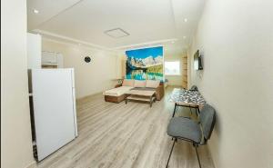 a living room with a couch and a table at Studio on Dostyq Street 5 floor 25 in Astana