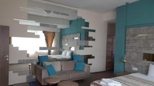 a bedroom with a couch and a bed in it at Hotel Emka in Tetovo +39 photos