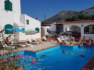 a group of people swimming in a swimming pool at Elia & Tina Apartments in Hersonissos