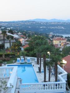 a view of a swimming pool from a resort at Apartments Villa Palme in Opatija