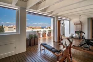 a room with a gym with a large window at Hotel Es Marès in Sant Francesc Xavier