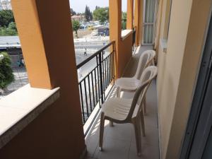 two chairs on a balcony with a view of a city at Delphi Hotel in Nicosia
