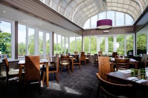 索爾茲伯里的住宿－傳統玫瑰與王冠酒店，用餐室设有桌椅和窗户。
