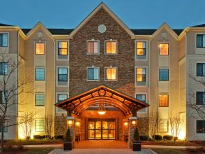 a large brick building with a clock on the front of it at Staybridge Suites Glenview, an IHG Hotel in Glenview