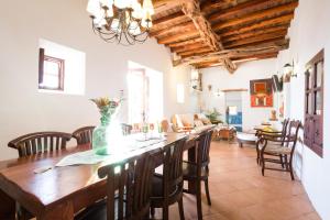 a kitchen and dining room with a wooden table and chairs at Can Caseres in Santa Eularia des Riu