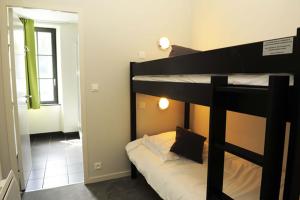 a bedroom with a bunk bed in a room at Hôtel Restaurant Corto Maltese in Le Palais