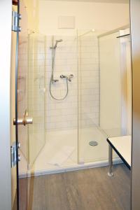 a bathroom with a shower with a glass door at Tagungshaus Kloster Heiligkreuztal in Altheim