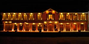 a building lit up at night with lights at Hotel Jardines de Uyuni in Uyuni