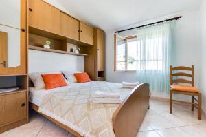 Posteľ alebo postele v izbe v ubytovaní Apartmani Prkačin