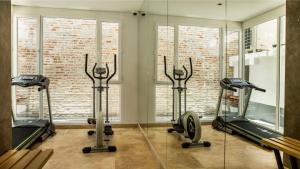 a gym with several treadmills and mirrors at GHL Arsenal Hotel in Cartagena de Indias