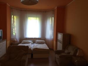 Postel nebo postele na pokoji v ubytování Pálma Apartmanház Siófok