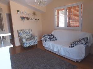 a living room with a couch and a chair at Maja's Place Apartments in Korčula