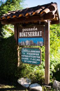 a sign for a monument in a park at Pousada Montserrat in Visconde De Maua