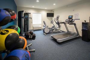a fitness room with a treadmill and exercise equipment at Uptown Suites Extended Stay Charlotte NC - Concord in Concord