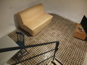 a chair sitting on a floor next to a table at Central old stone Jerusalem apartment in Jerusalem
