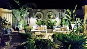 a patio with couches and potted plants at Lisbon Garden Boutique Guest House in Lisbon