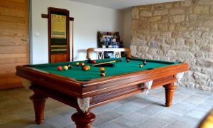 a pool table with balls on it in a room at La Maison Des Jardins in Auriac