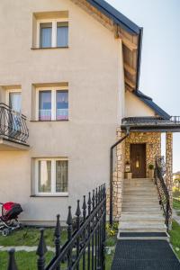 a house with a staircase leading to the front door at Hawet in Jastrzębia Góra