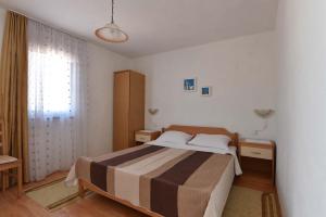 a bedroom with a bed and a large window at Apartmani Marko in Gdinj