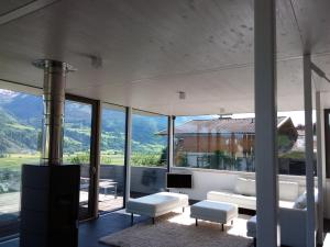 a living room with a view of the mountains at Glas House - Design Holiday Home in Piesendorf
