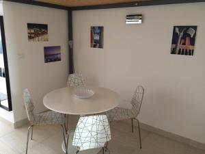 a dining room with a white table and chairs at Sea Loft in Genova +9 photos