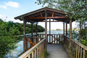 a woodenvisor over a bridge over a river at Playa De Arnadal Isla in Isla