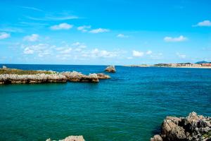a view of the ocean with rocks in the water at Playa De Arnadal Isla in Isla +27 photos