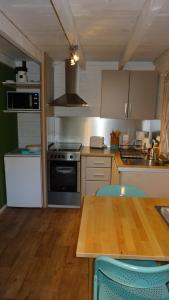 a kitchen with a table and a stove top oven at Le Clos de Mesvres in Civray-de-Touraine