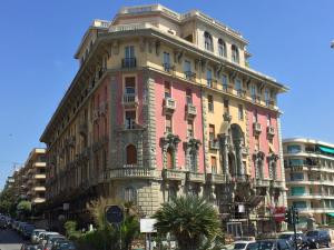 a tall building on a street with cars parked in front at Sea Loft in Genova