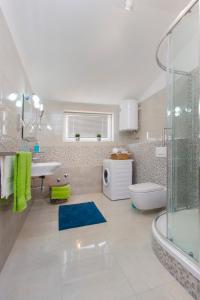 a bathroom with a shower and a sink and a toilet at Luxury Apartment Ante in Kaštela