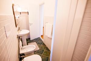 a bathroom with a toilet and a sink at La Via Del Mare in Palinuro