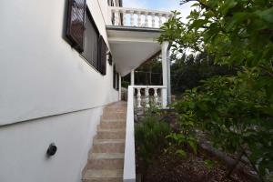 a stairway leading up to a white house at Apartmani Marko in Gdinj