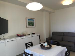 a living room with a table and a couch at Stella Del Mare Privato in Francavilla al Mare