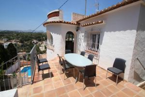 a balcony with a table and chairs on a house at El Atarceder-6 - sea view villa with private pool in Benissa in Benissa