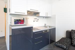 a kitchen with a sink and a microwave on a counter at Luxurious Apartments Maslina with Beach in Milna