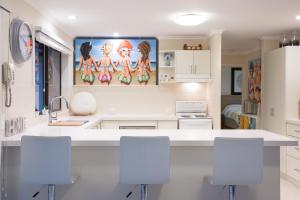 a kitchen with white counters and white cabinets at Beach House Getaway 2 in Smiths Beach