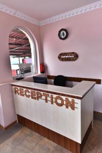 a reception desk with a regleton sign on the wall at Haghpat Hotel in Haghpat