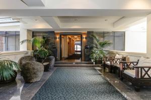 a lobby with chairs and plants in a building at New York On King in Perth