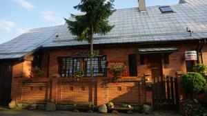 a brick house with a palm tree in front of it at Pas Birute in Kaunas