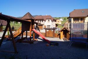 a playground with a slide and a swing set at Dacha in Yasinya
