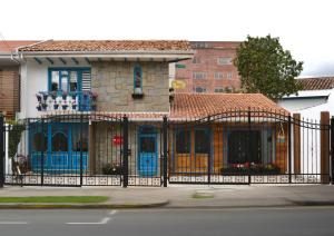 a house with an iron fence in front of it at La Casa Azul in Cuenca