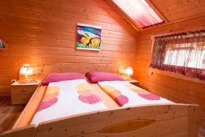 a bedroom with a bed in a log cabin at Reiterbauernhof Maho in Sankt Aegyd am Neuwalde