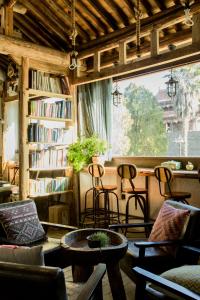 a living room with chairs and a book shelf at Hidden Hotel in Dali
