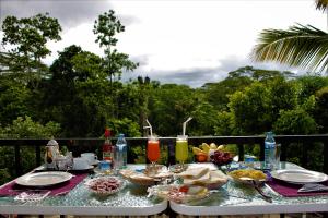 a table with food and drinks on top of it at e-stay Hanthana Kandy in Kandy