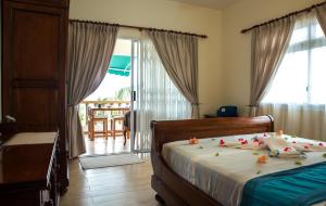 Voodi või voodid majutusasutuse Seashell Beach Villa toas