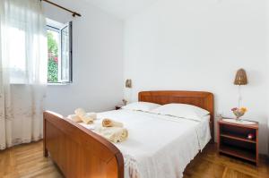 Posteľ alebo postele v izbe v ubytovaní Apartmani Prkačin