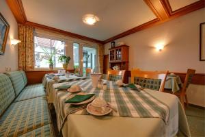 a dining room with a long table with dishes on it at Hotel Adler in Nagold