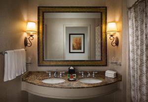 a bathroom with a mirror and a sink at La Cantera Resort & Spa in San Antonio